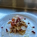 -Cips di polenta integrale con crema di radicchio e noci, servite con bacon, salsa al pecorino e chicchi di melograno - -