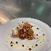 -Cips di polenta integrale con crema di radicchio e noci, servite con bacon, salsa al pecorino e chicchi di melograno - -