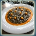 Fregola al nero di seppia con sferificazione di zucca al lime - -