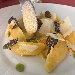 Gnocchi di patate farciti al pecorino, fave e guanciale, cipolla rossa salsa all'uovo arancia e tartufo nero - -