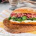 Panino con Salame di Milano, robiola, miele, noci e soncino - -